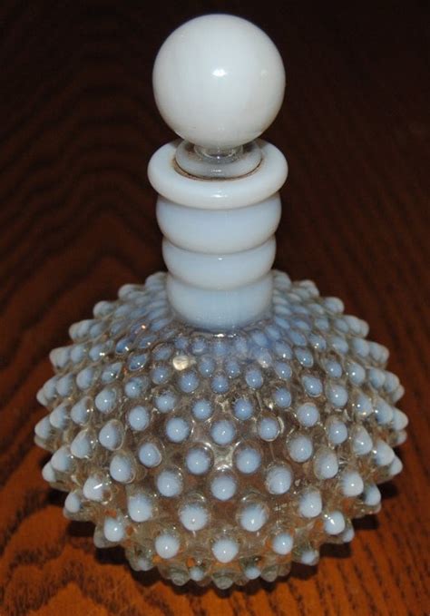 Antique Fenton Perfume Bottles Cranberry Opalescent Hobnail Pink Cologne Bottle Glass Stoppers Vanity Set This is a Fenton Cranberry Opalescent Hobnail set of perfume/cologne bottles that were made by Fenton Art Glass. It is very collectible. It was produced from 1940 to 1956 during war years
